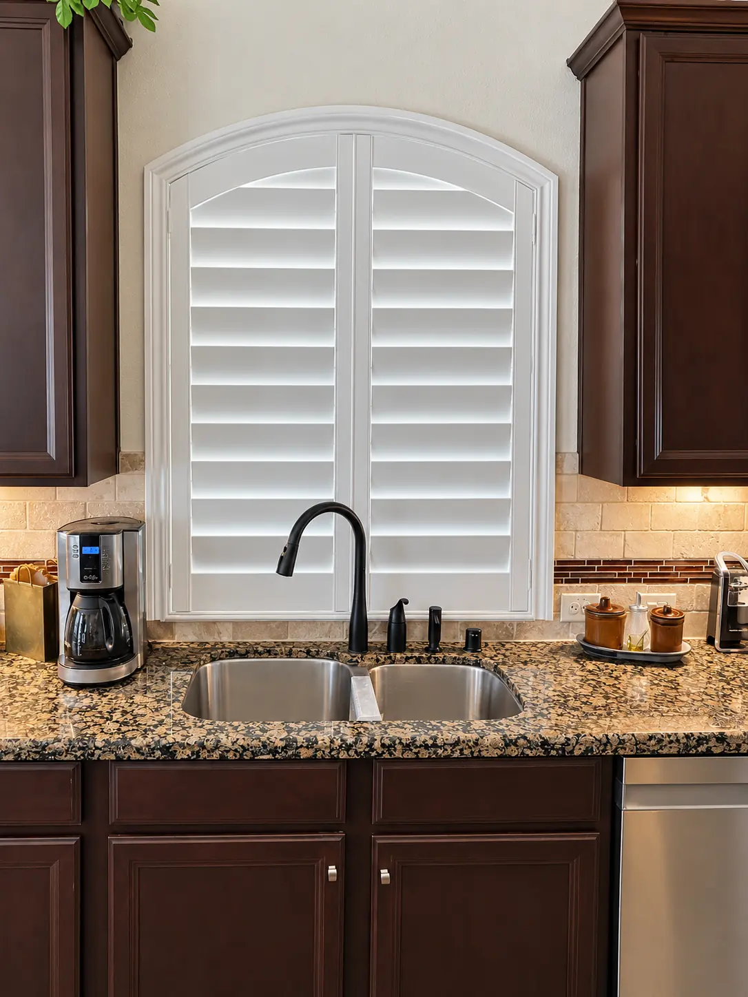 Custom arched plantation shutter above a kitchen sink