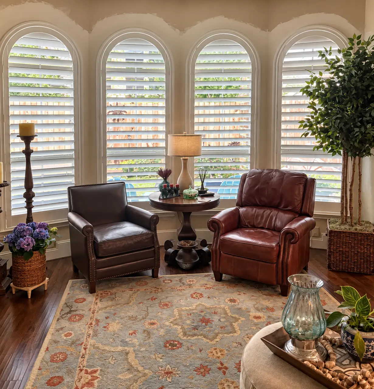 Four arched living room windows fitted with white plantation shutters
