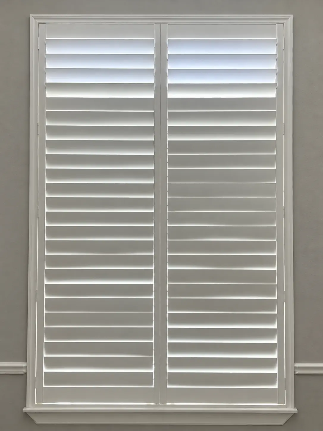 Plantation shutter louvers shown in a tightly closed position